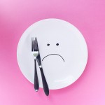Plate with sad face on it, symbolizing an eating disorder