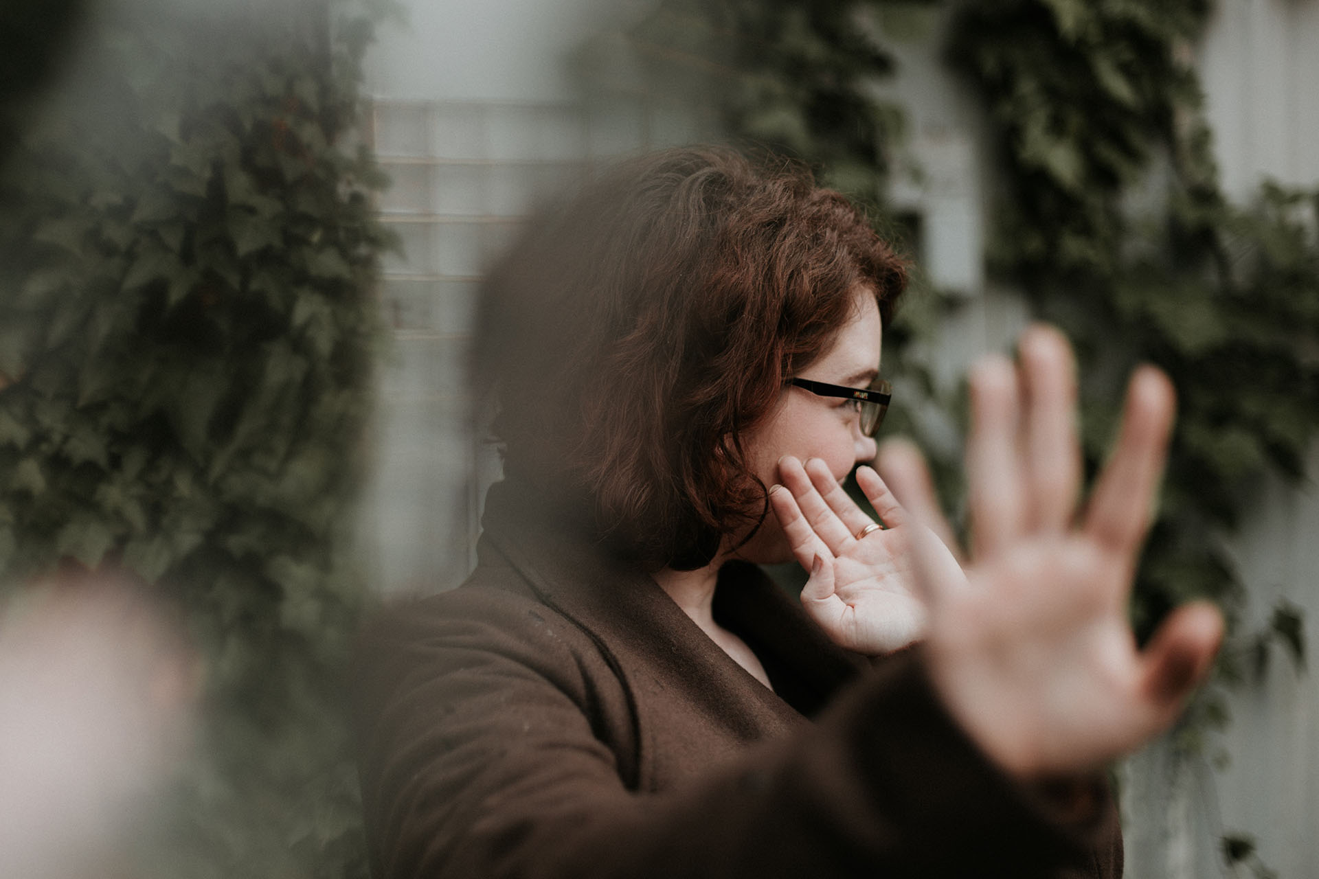 a woman putting her hand out and resisting an offer