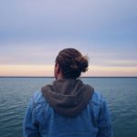 man staring at ocean