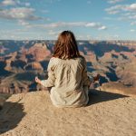 girl meditating on cliff