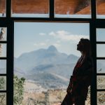 woman leaning in doorway thinking about emotions