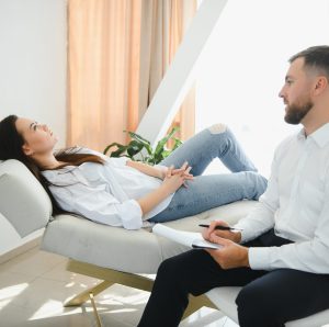 Male doctor and female patient at therapy session.