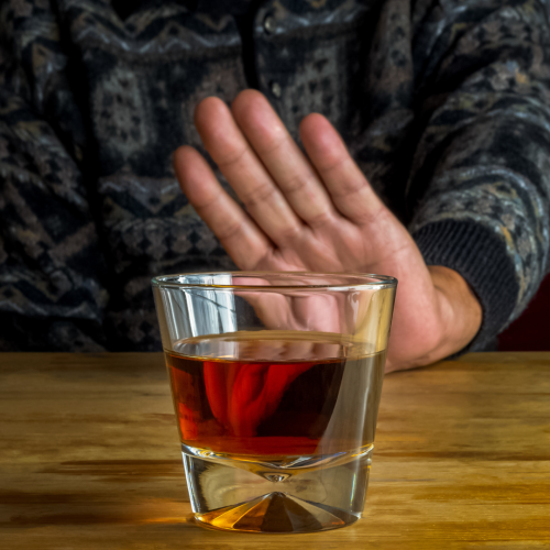 A person rejecting a drink